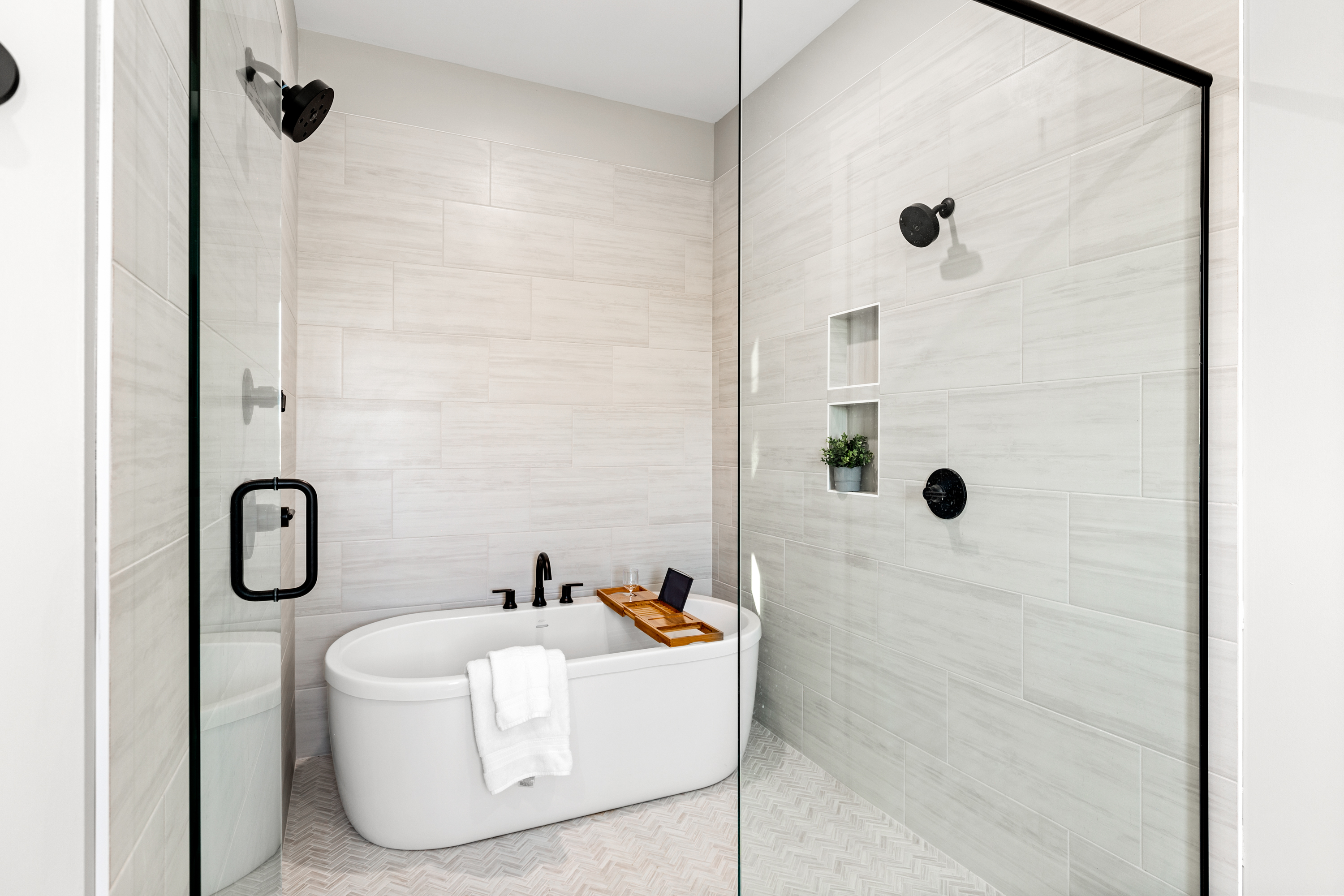 Luxurious walk-in shower with freestanding bathtub and modern fixtures
